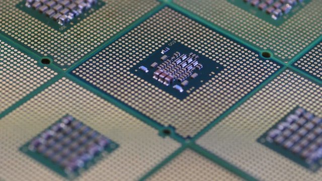 Closeup of Computer Chip Processors aligned on rotating dolly.