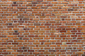 Natural old vintage weathered red brown solid brick wall. Abstract copy space background.