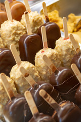 Variety of homemade chocolate, vanilla, almonds ice cream bars on sticks