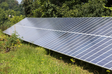 Modern saving efficient stand -alone blue shiny solar photo voltaic panels system producing...