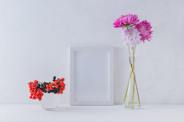 Mockup with a white frame and pink flowers in a vase