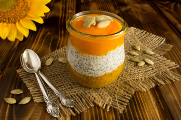 Obraz na płótnie Canvas Pudding with chia and pumpkin on the rustic wooden background