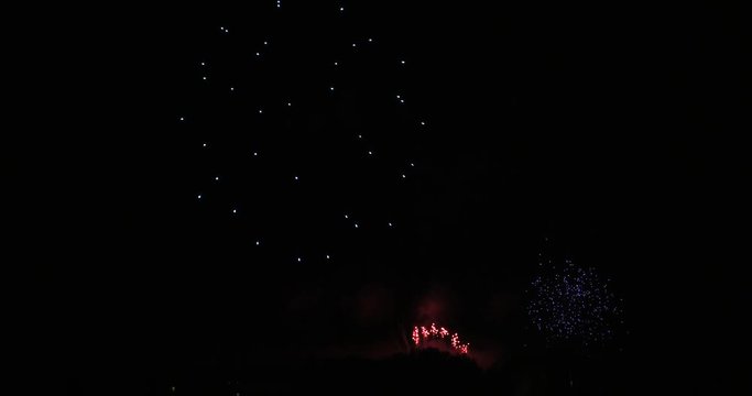 The fireworks in the night sky. Holiday celebration. Colorful and amazing fireworks at holiday night.  .