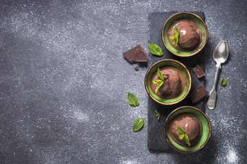 Chocolate ice cream top view on black.