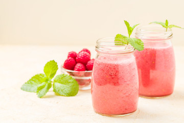 Raspberry smoothie close up photography with fresh summer blended cocktail and ripe berries.