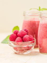 Raspberry smoothie close up photography with fresh summer blended cocktail and ripe berries.