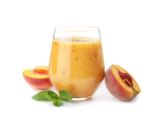 Naklejka na ściany i meble Tasty peach smoothie in glass and fresh fruit on white background