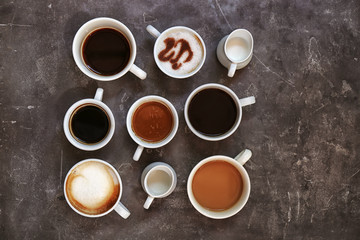 Obraz na płótnie Canvas Cups of fresh aromatic coffee on grey background, top view