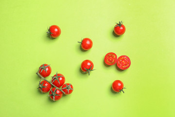 Naklejka na ściany i meble Flat lay composition with tasty cherry tomatoes on color background