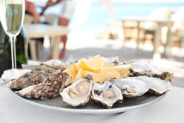 Fresh oysters with cut juicy lemon served on table