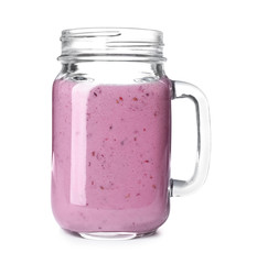 Mason jar with blackberry yogurt smoothie on white background