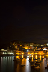 Fototapeta na wymiar Romantic Time at The Bay of Sestri Levante at the Blue Hour in Summer With Boats Moored