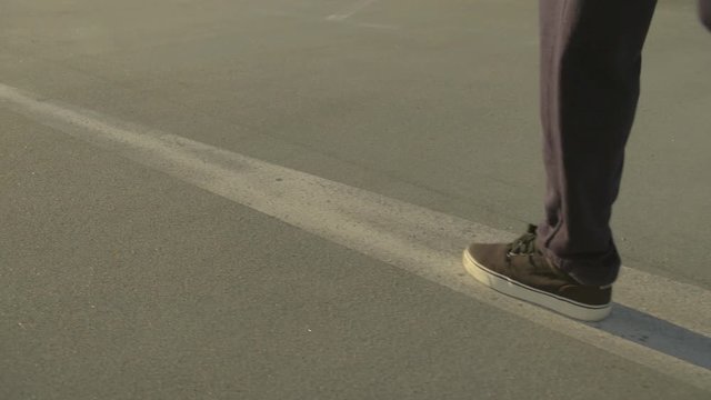young female Hip hop dancer kicks away a can on the road