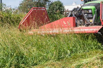 Mow grass with tractor and mower