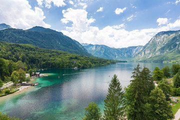 Bohinj lake, Slovenia. View of lake from top of near church. Blue water in summer day, blue sky with clouds. Triglav national park