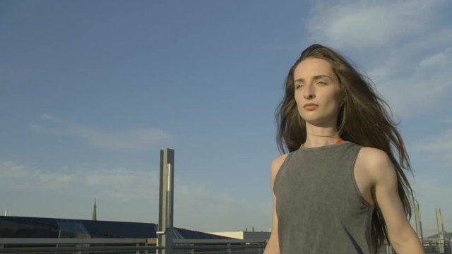  young hip hop dancer walks in sunset and kicks a tin off on the floor