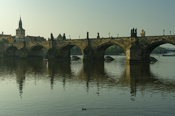 View of the panorama of the old historic center of Prague by the river and the Charles Bridge in the early morning