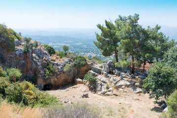entrance to Melidoni cave at the foot of the mountain on the island of Crete