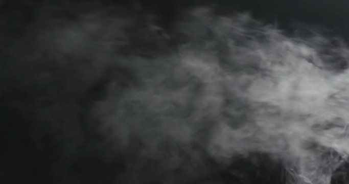 slow motion vapor steam from right over black background