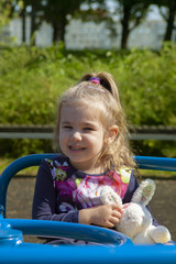 the little girl shakes on a swing in the park