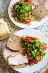 Tomatoes, scallions & basil salad with ham sandwiches and cheese 