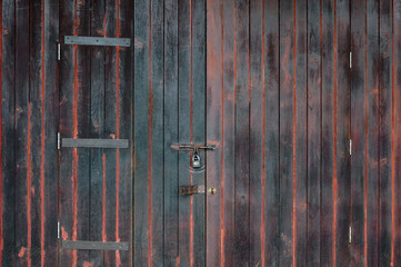 Old vintage brown wooden door with key locked