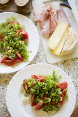 Tomatoes, scallions & basil salad with ham sandwiches and cheese 