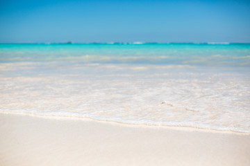 Fototapeta na wymiar Sea water and blue sky with white sand. Horizon line in Dominican