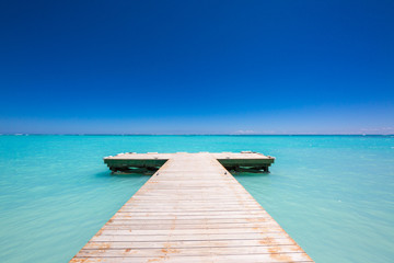 wooden Pier blue sky on background and caribbean sea