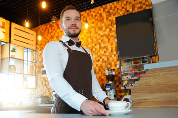 A barista with cup of hot coffee