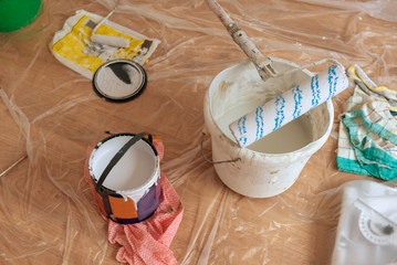 Painting roller with paint and essentials equipment. Home renovation.