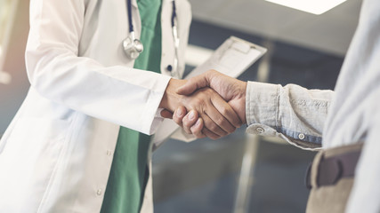 Health worker and patient shaking hands