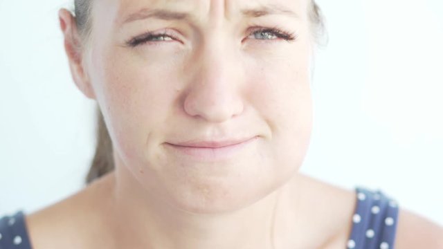 Woman with a flux on her cheek. At the girl after implantation of a tooth there was an edema and a bruise on a cheek. She tries to smile