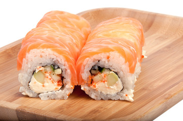 tasty sushi roll on the wooden board background