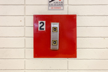 Red elevator buttons with white tiles