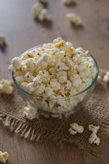 bowl of popcorn on wooden surface
