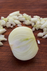 Cut in half onion close-up on a wooden background, vertical frame.