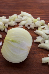 Slice the bulbs on a wooden background along with finely chopped onions, vertical frame.