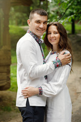 Fototapeta premium Beautiful bride and groom in the ukrainian style are standing w