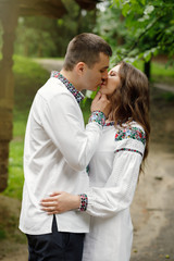  Beautiful bride and groom in the ukrainian style are standing w