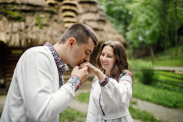  Beautiful bride and groom in the ukrainian style are standing w