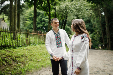 Fototapeta premium Beautiful bride and groom in the ukrainian style are standing w