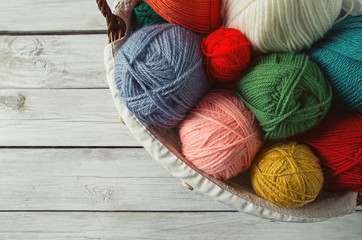 colorful yarn balls on wooden surface