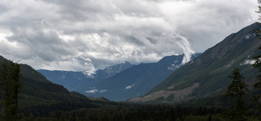 Heavy rain moves across a dramatic valley in the Canadian wilderness