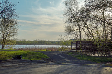 Trail and bridge overlooking lake at Purgatory Creek Park in Eden Prairie, Minnesota