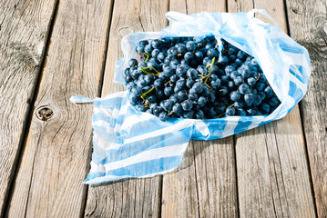 red grapes on old weathered wooden table