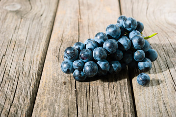red grapes on old weathered wooden table