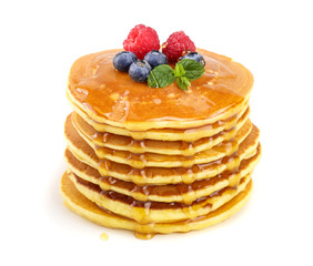 Pancakes stack with different berries and honey isolated on white background