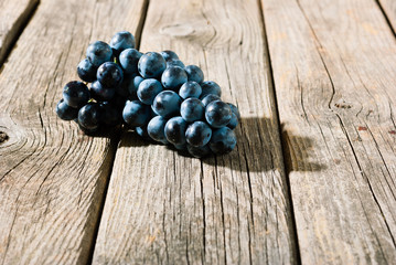 red grapes on old weathered wooden table