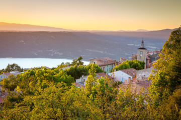 View of Aiguines village with charming church overlooking Lac de Sainte Croix Lake, Var department, Provence, France - 218552676
